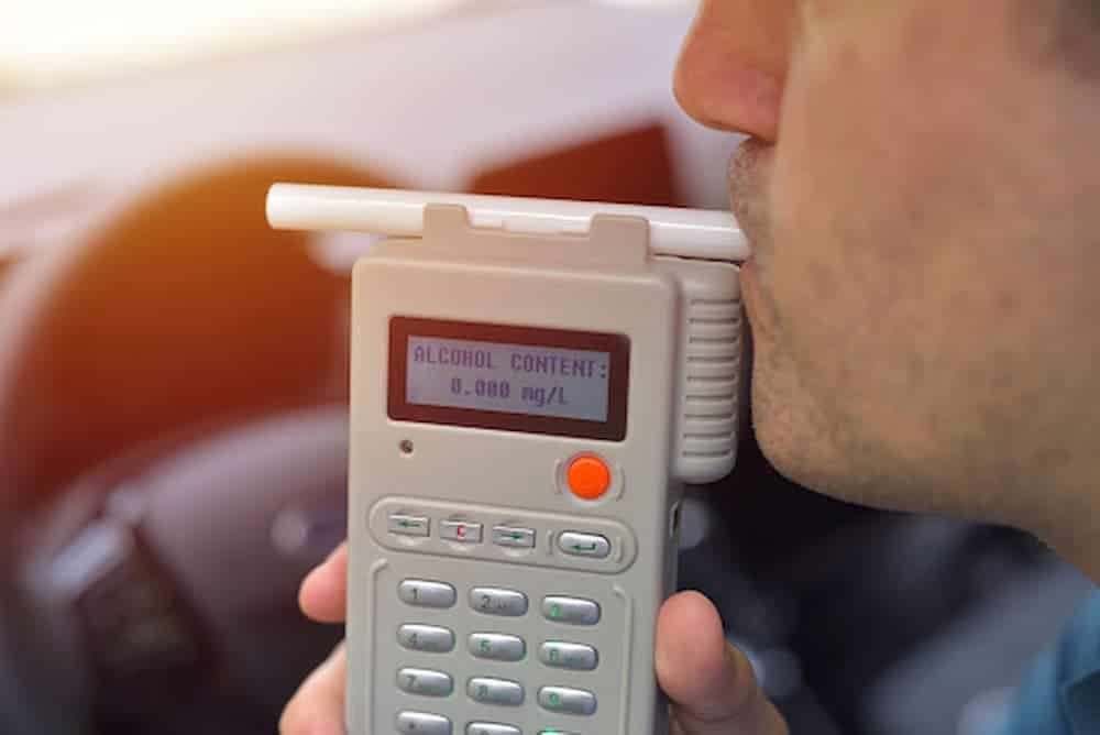 Driver being subjected to breathalyzer test