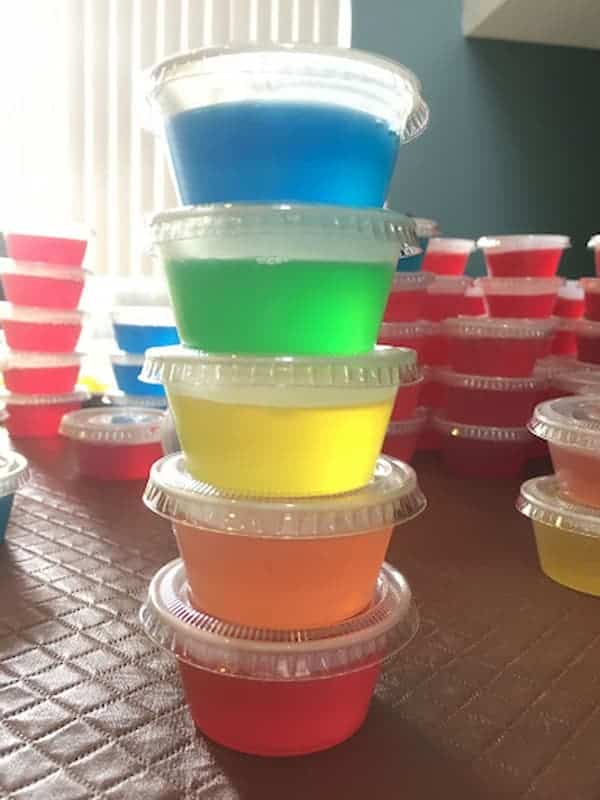 Multi-colored-jello-shots-stacked-in-plastic-containers