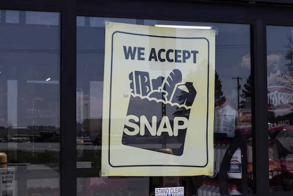 Sign in store window reading "We Accept SNAP"
